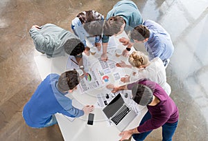 Overhead view of professional businesspeople discussing and brainstorming together photo