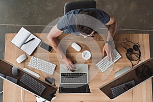 overhead view of programmer using computers