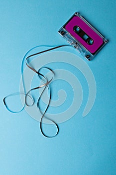 Overhead view of purple cassette tape with copy space on blue background