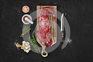 Overhead view of raw beef tri-tip loin on cutting board