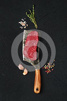 Overhead view of raw boneless strip loin steak on cleaver