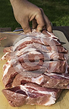 Overhead view of raw piece of pork on wooden background. Piece of fresh boneless pork, neck part or collar. Big piece of red raw m