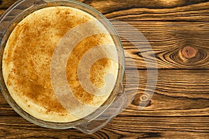 Overhead view of rice pudding in round glass dish