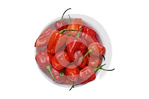 Overhead view of ripen Capsicum Chinense chili pepper pods put in a white ceramic bowl