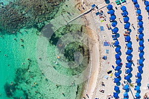 Overhead view of Sandy Bay beach in Cyprus with swimmers and sunbathers