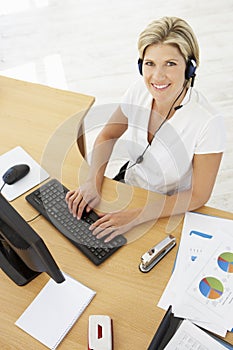 Overhead View Of Service Agent Talking To Customer In Call Centre