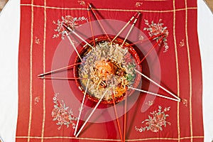 Overhead view on serving of yusheng or yee sang with raw salmon belly during Chinese New Year with chop sticks laid