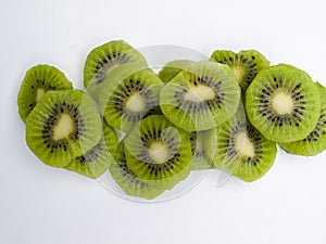 Overhead view of several slices of green kiwis