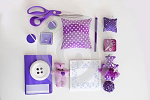 Overhead view of sewing tools and accessories. Purple concept.
