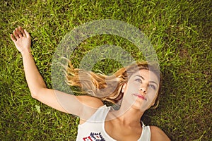 Overhead view of smiling woman lying on grass