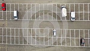 Overhead View of Sparse Parking Lot with Vehicles in Marked Spaces