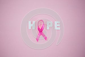 Overhead view of spotted Breast Cancer Awareness ribbon with HOPE text