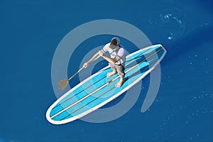 Overhead view of stand up paddleboarder