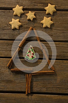 Overhead view of star shape cookies by Christmas tree made with cinnamon stick