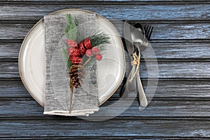 Overhead view of  table setting - a plate with spoon, fork and knife with a Christmas decoration