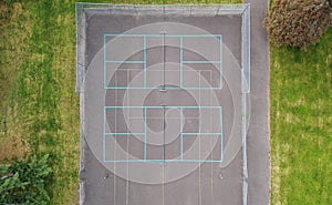 Overhead view of tennis court with bright blue boundry lines