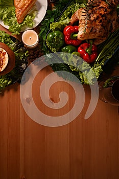 Overhead view of Thanksgiving table or Christmas dinner with baked turkey and all sides dishes. Copy space for your text