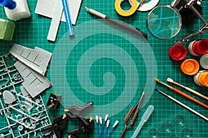 Overhead View Of Tools And Materials For Building Scale Model Aeroplane From Kit On Cutting Board