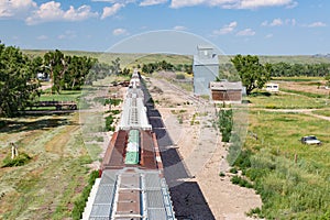 Overhead View of Train Passing Old Grain Elevator