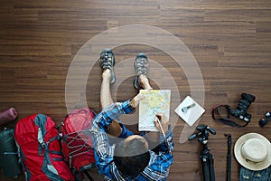 Overhead view of traveler man plan and backpack planning