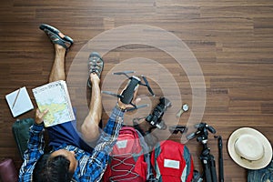 Overhead view of traveler man plan and backpack planning vacatio