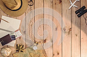 Overhead view of Traveler`s accessories Essential vacation items, and Different objects on wooden background. Travel concept