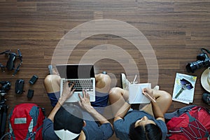 Traveler`s Young couple backpack working on laptop computer