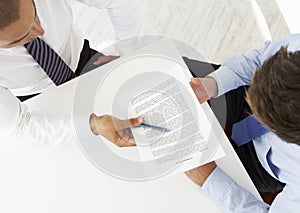 Overhead View Of Two Businessmen Working At Desk Together