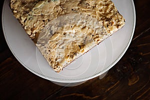 Overhead view of  white  chocolate cake with chocolate rice on a white plate
