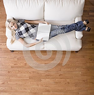 Overhead View of Woman With Book on Couch