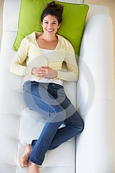 Overhead View Of Woman Relaxing On Sofa