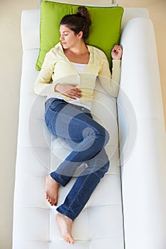 Overhead View Of Woman Relaxing On Sofa