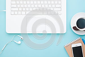 Overhead view of working space with white laptop, mobile device and cup of coffee, Business and online marketing on pastel color