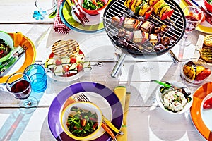 Overhead Well Laid summer table with colorful dish and brazier photo