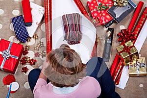 Overhead woman wrapping her Christmas presents.