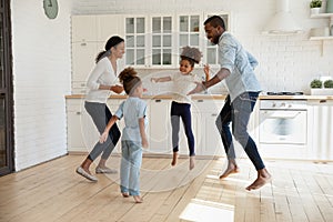 Overjoyed african american couple jumping with joyful energetic children.