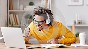 Overjoyed african american man looking at laptop screen feeling excited after receiving job offer