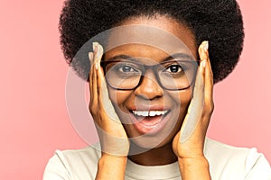 Overjoyed african female emotional with mouth open. Excited young black woman in eyeglasses amazed