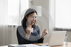 Overjoyed asian lady office worker get reward promotion by email