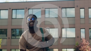 Overjoyed biracial male student guy high school pupil African American man in city outdoors scream passing exam getting