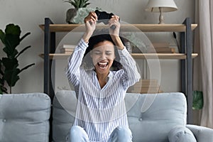 Overjoyed biracial woman play computer video games