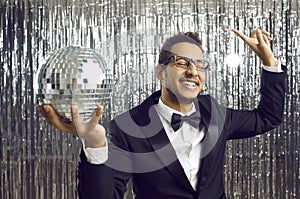 Overjoyed black man with disco ball partying