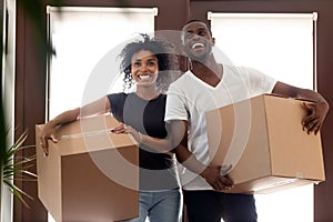 Impressed black couple entering new home on moving day photo