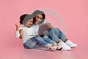 Overjoyed Black Mom And Little Daughter Celebrating Success With Laptop