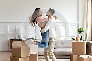 Overjoyed couple dancing excite to move in together