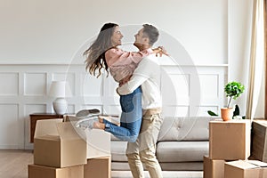 Overjoyed couple dancing excite to move in together photo