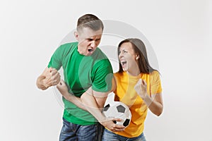 Overjoyed couple, woman man, football fans in yellow green t-shirt cheer up support team with soccer ball doing winner