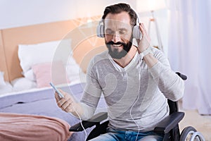 Overjoyed crippled man listening to music