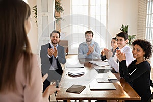 Overjoyed diverse businesspeople applaud coach for presentation