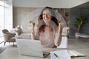 Overjoyed emotional businesswoman showing yes gesture, celebrating success